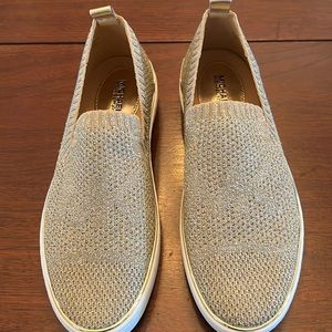 Michael Kors gold sneakers. never been worn. size 7 but fit like 7 1/2